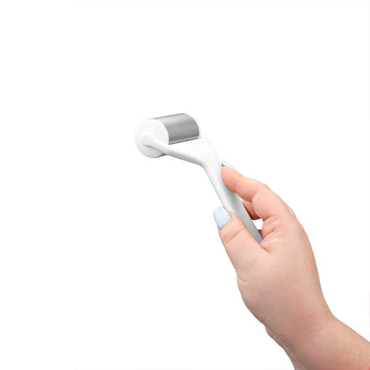 a hand holding the cold massage roller